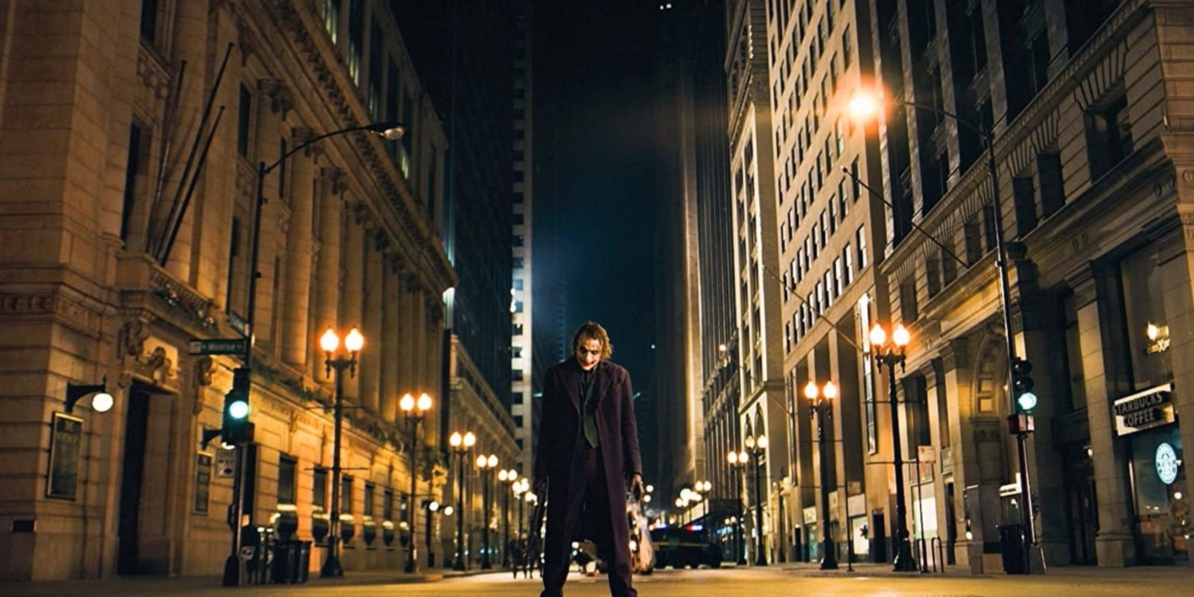 The Joker standing in the middle of an empty street in The Dark Knight