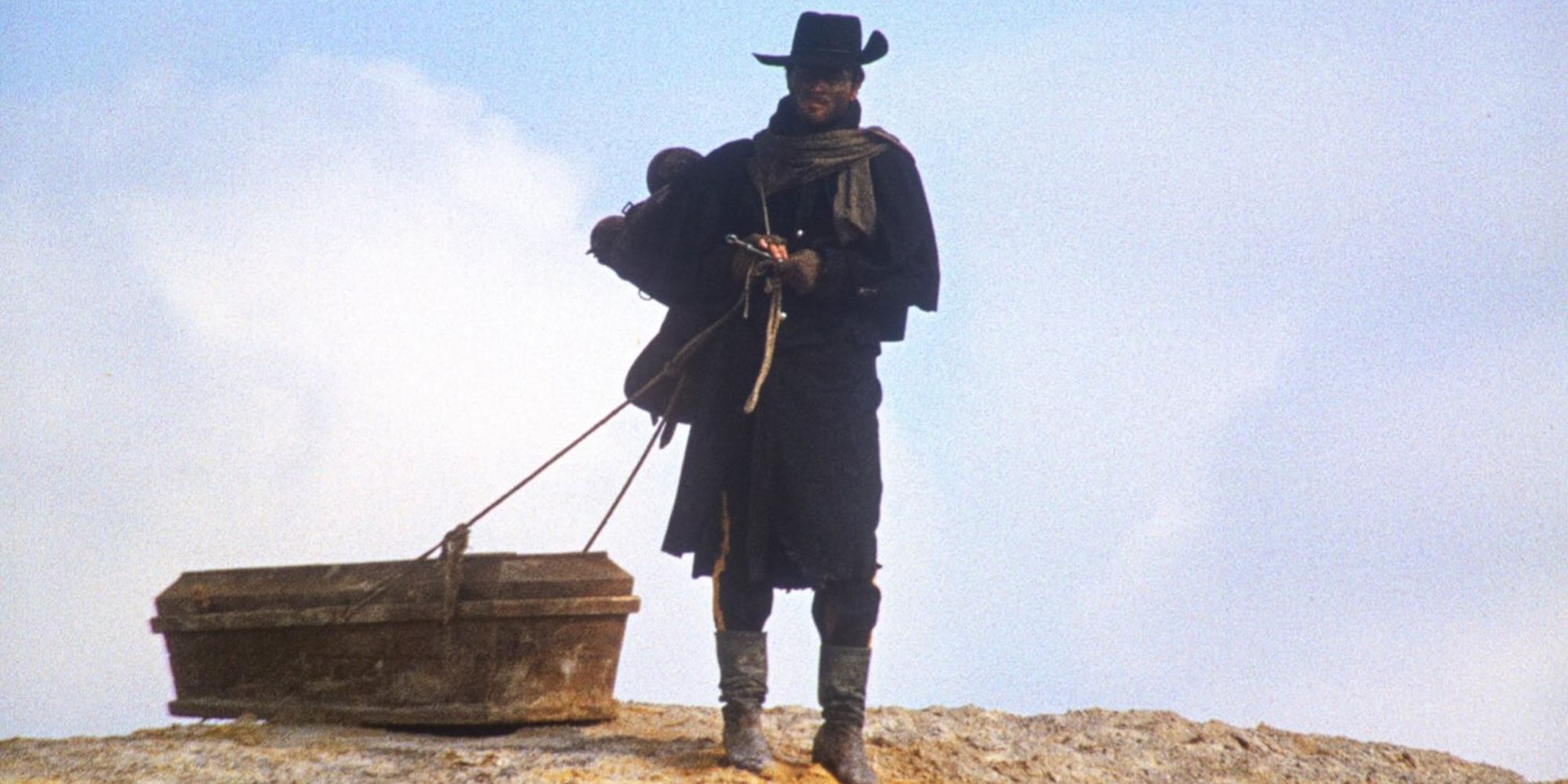 Franco Nero as Django Drags His Coffin Around a rocky, desert landscape.