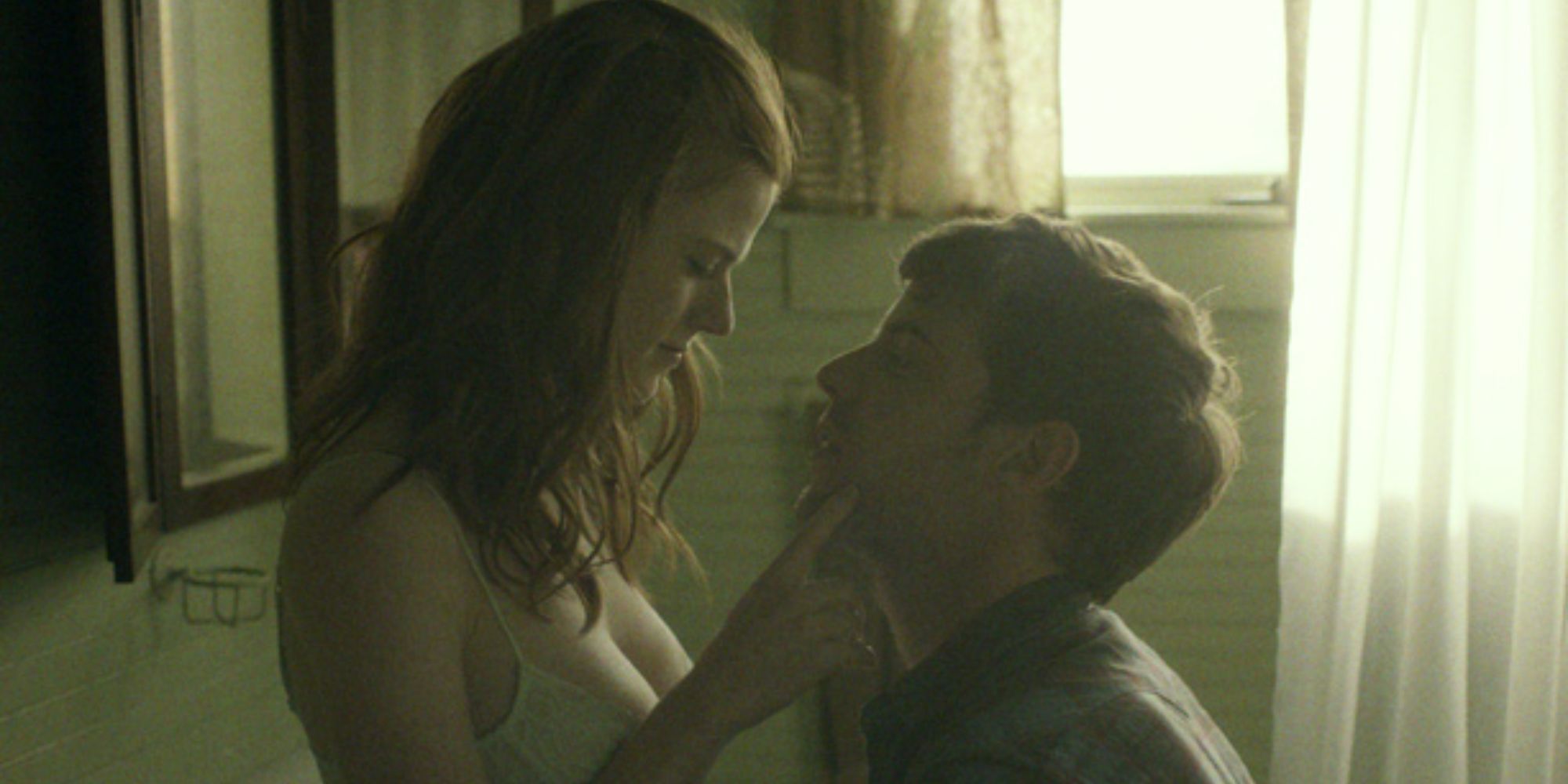 Bea (Rose Leslie) and Paul (Harry Treadaway) look smitten in the bathroom in the 2014 film Honeymoon.