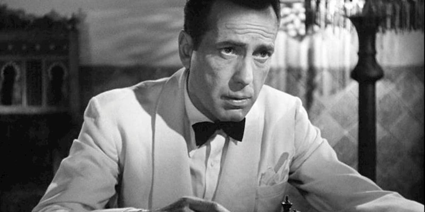 Humphrey Bogart as Rick Blaine looking seriously at something off-camera in Casablanca.