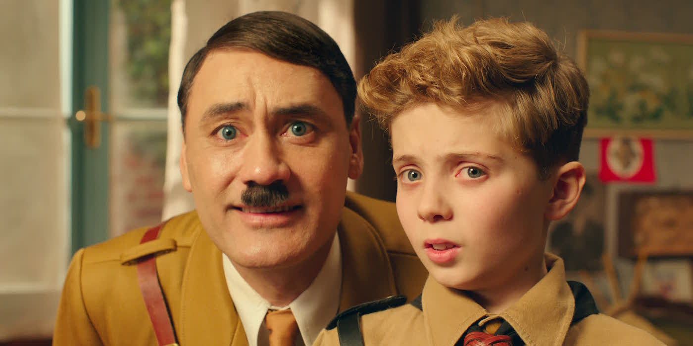 Takia Waititi as Hitler and Roman Griffin Davis as Jojo looking at the cmera in Jojo Rabbit