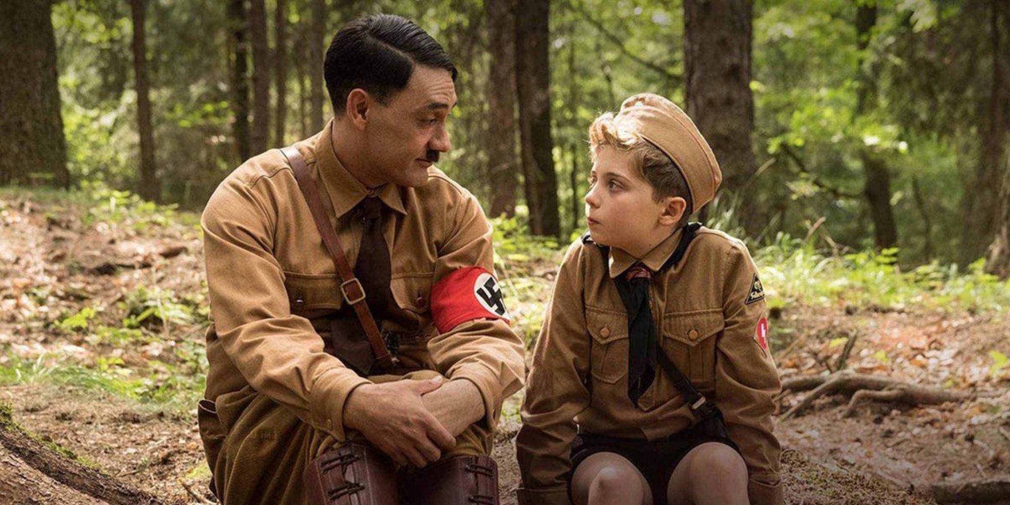 Roman Griffin Davis and Taika Waititi Jojo sitting with imaginary Hitler in 'Jojo Rabbit' (2019) 