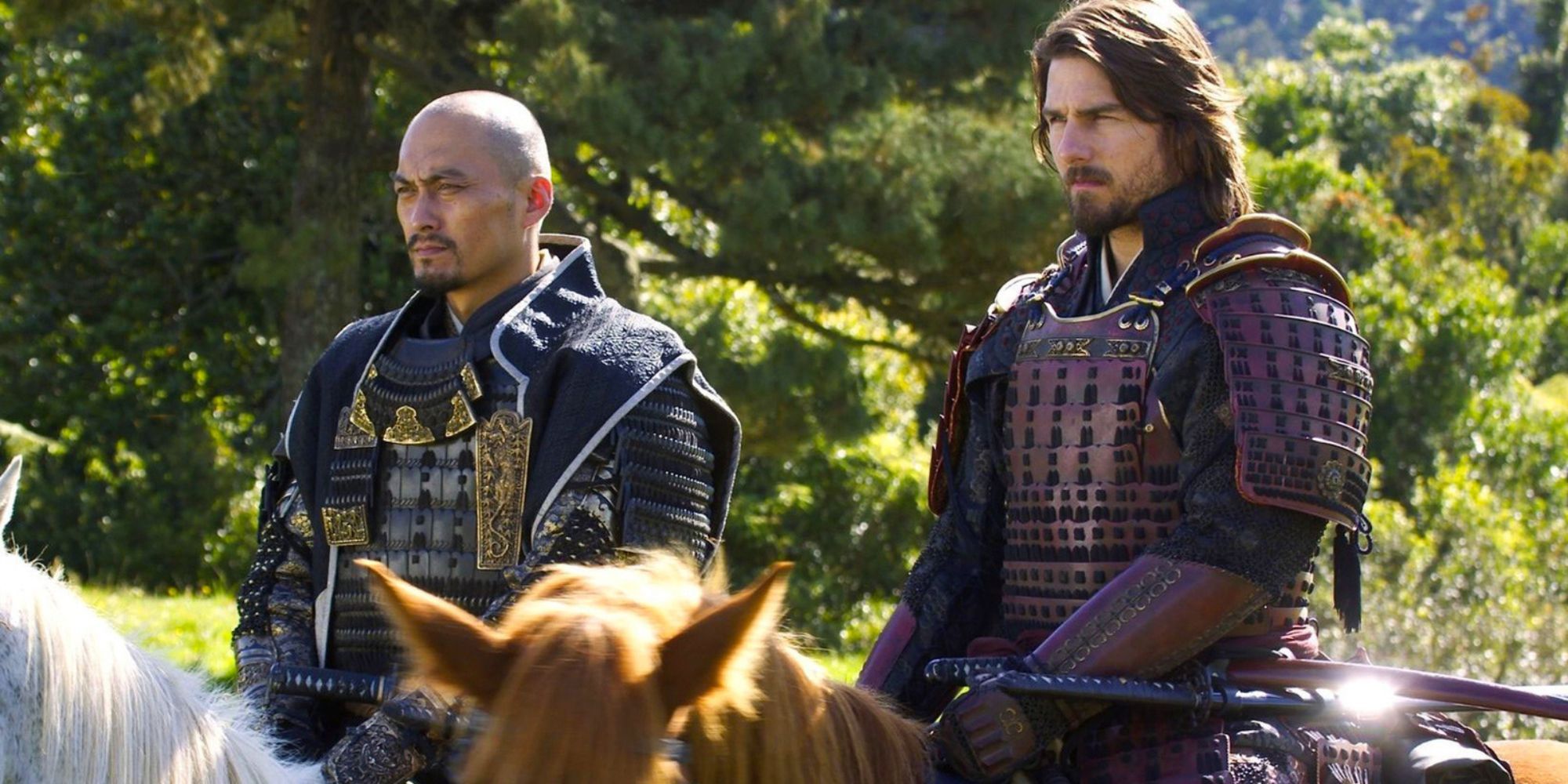 Tom Cruise as Nathan Algren and Ken Watanabe as Katsumoto ride together in The Last Samurai 