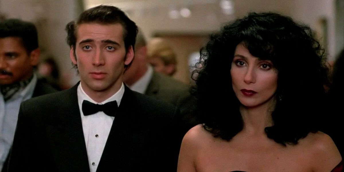 Nicolas Cage and Cher standing next to each other in Moonstruck 1987