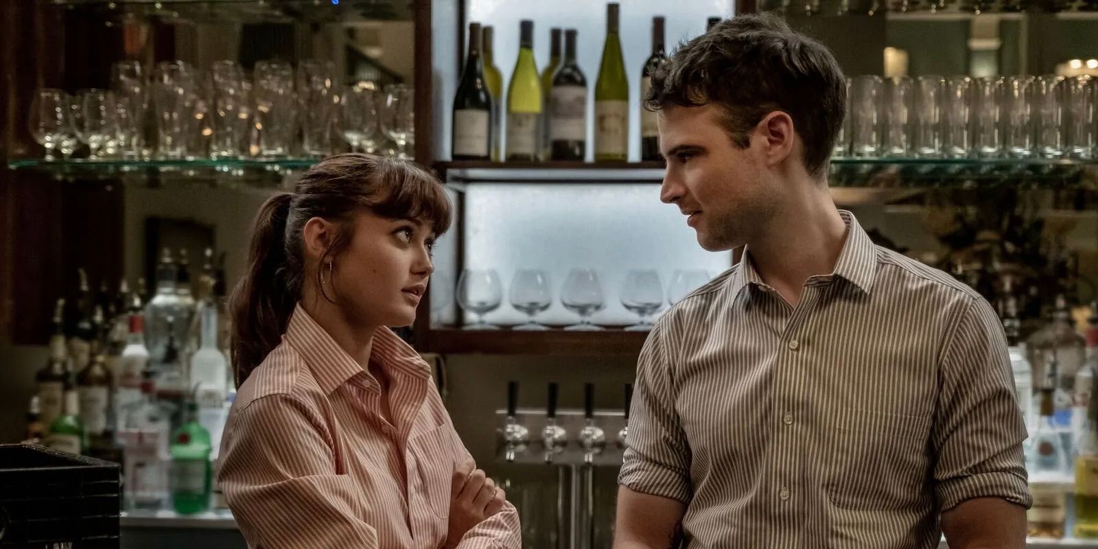 Tess and Jake talking behind a bar counter in Sweetbitter