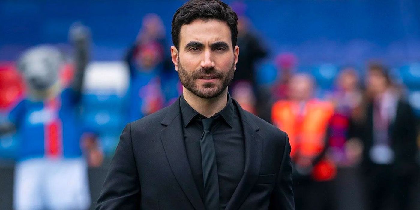 close-up of Brett Goldstein as Roy Kent in 'Ted Lasso', walking on the pitch wearing an all-black suit