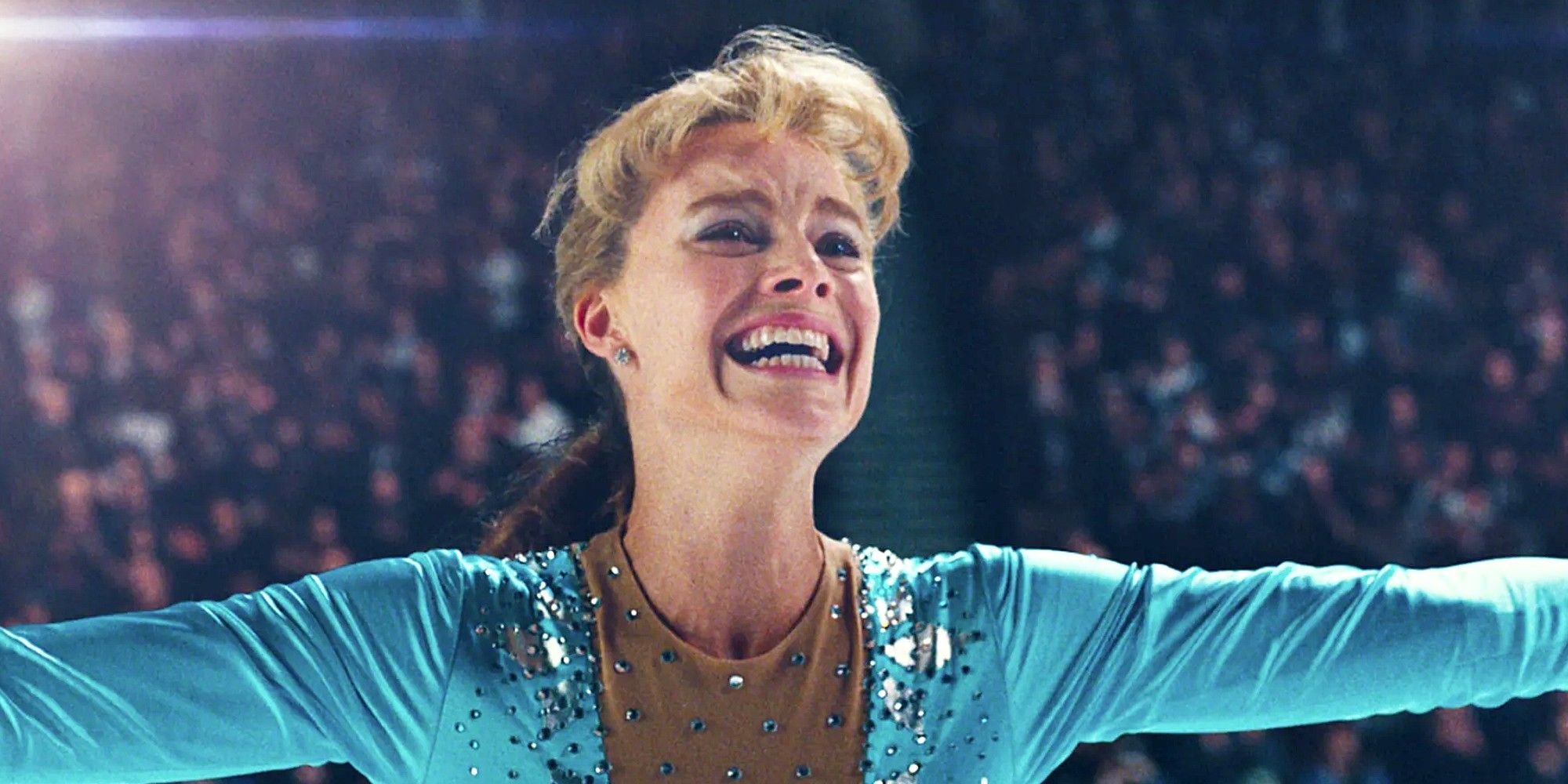 Tonya Harding skating while smiling with her arms spread in I, Tonya.