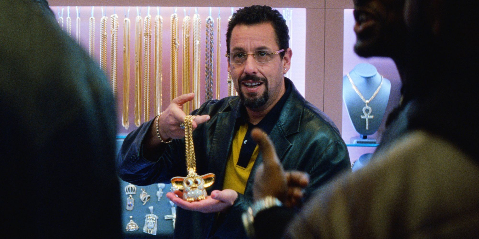 Adam Sandler holding necklace in Uncut Gems