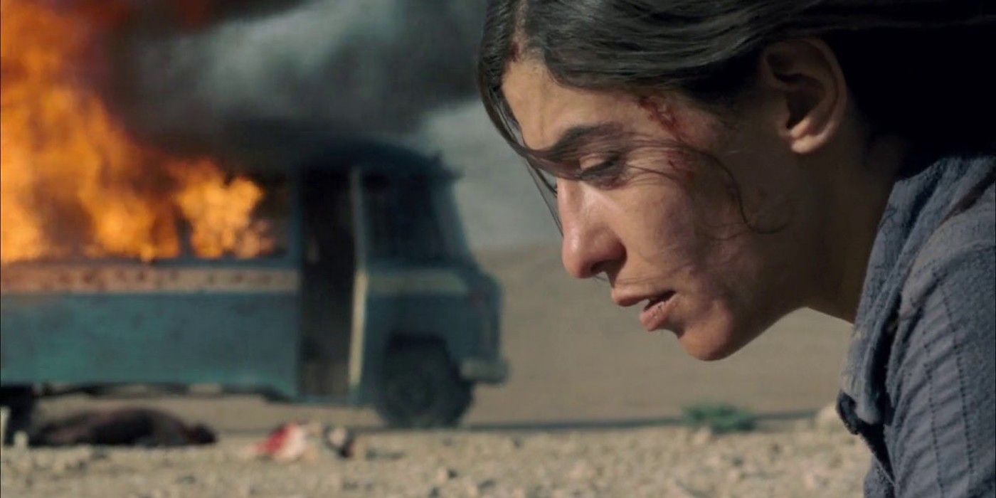 Lubna Azabal as Nawal Marwan looks distraught in front of a burning wreckage