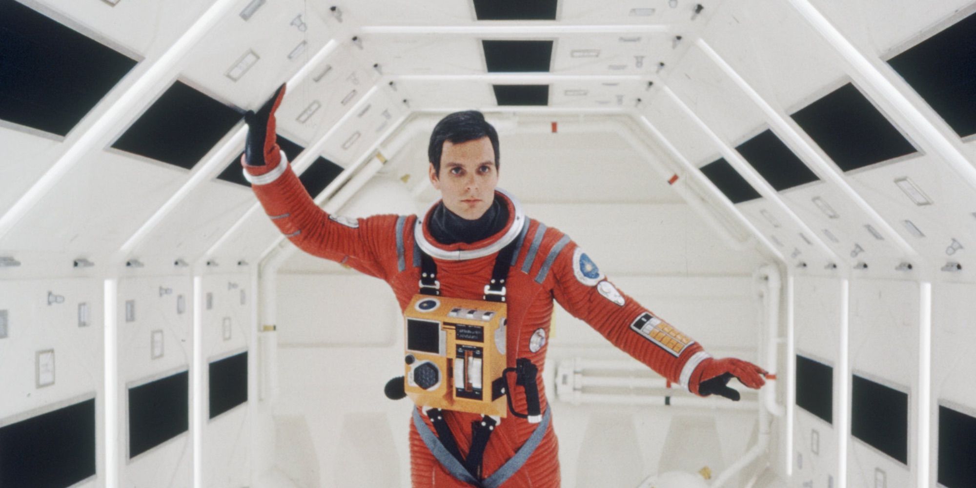 An astronaut walking down a spaceship corridor in 2001: A Space Odyssey.