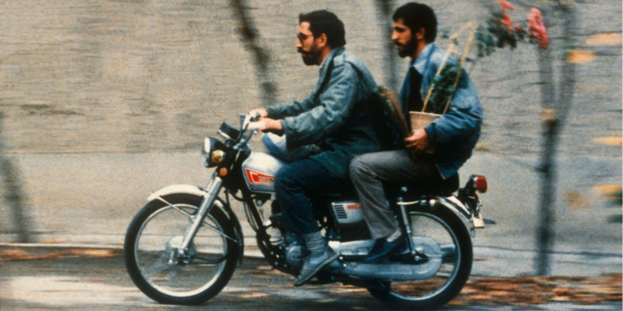 Mohsen Makhmalbaf and Hossain Sabzian as Mohsen and Hossain, riding a motorcycle in Close-Up