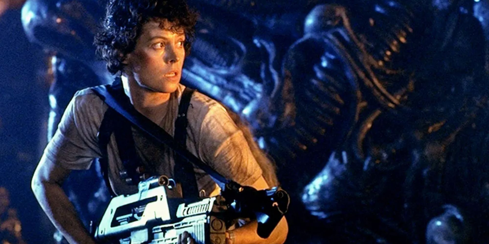 Sigourney Weaver as Ripley in 'Aliens' holding a large gun
