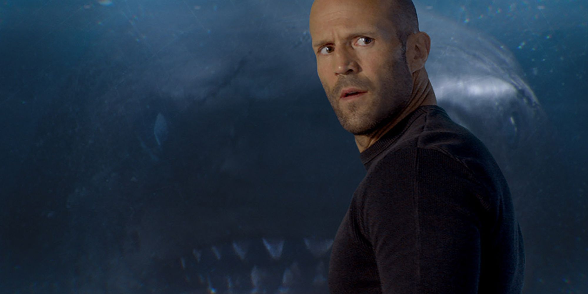 Jonas Taylor avec le mégaladon derrière lui dans The Meg.