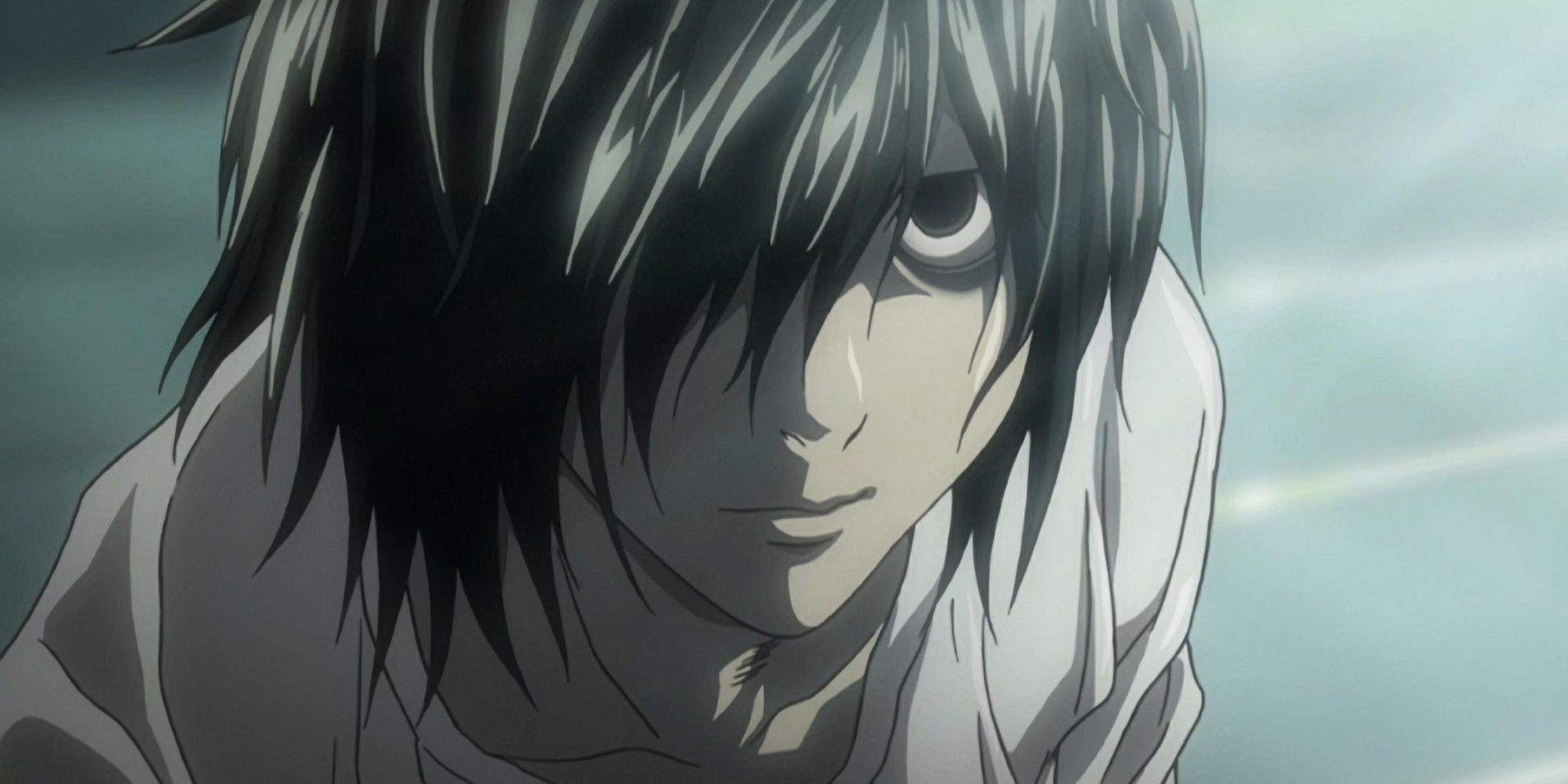 L with his hair coering his face, looking up at Light Yagami, in Death Note.