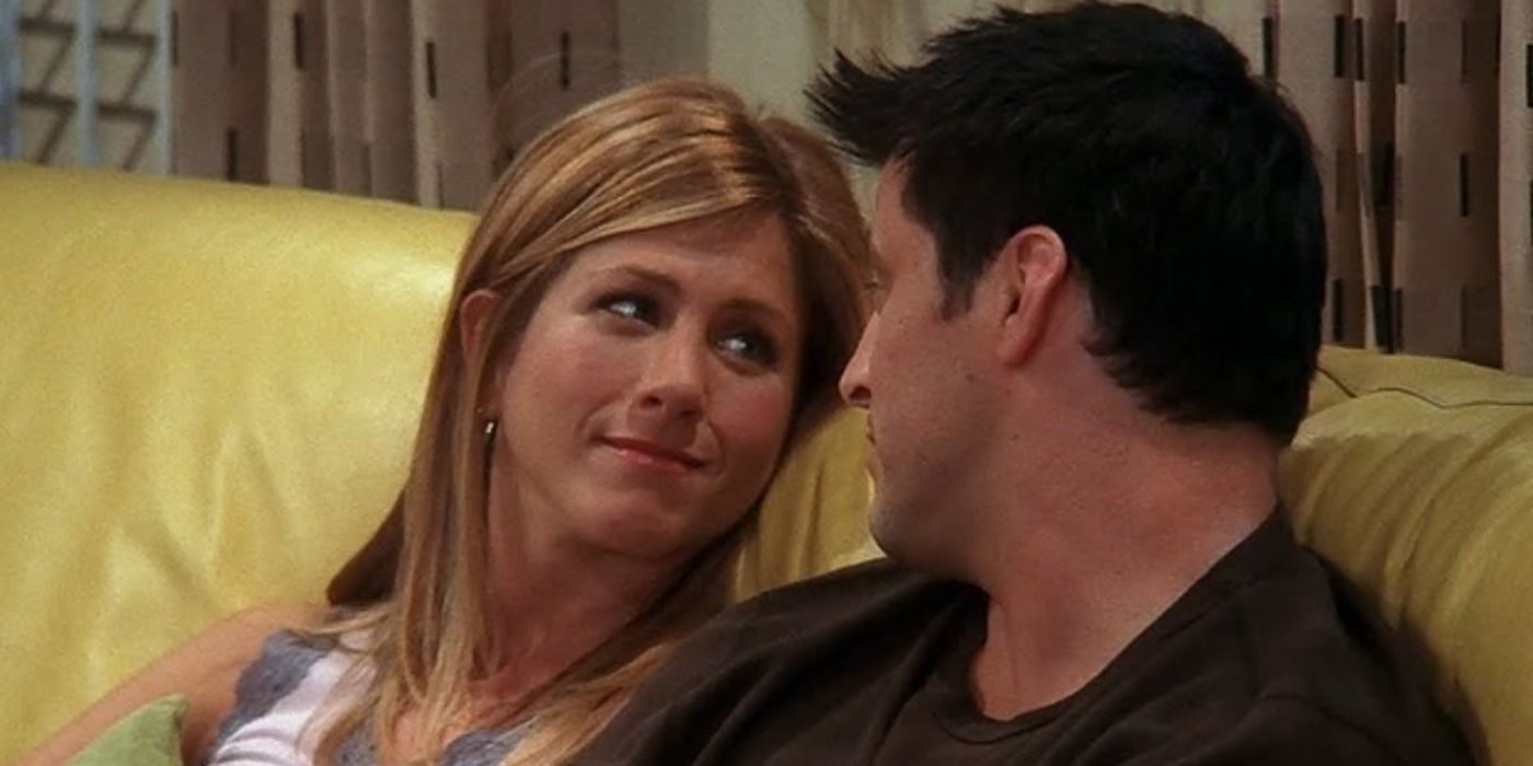 Matt LeBlanc as Joey and Jennifer Aniston as Rachel looking at each other on a couch in Friends