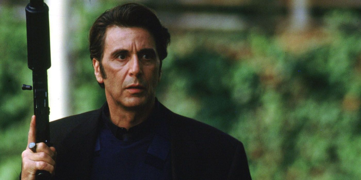 Al Pacino as Vincent Hanna holding a gun and looking intently off camera in Heat