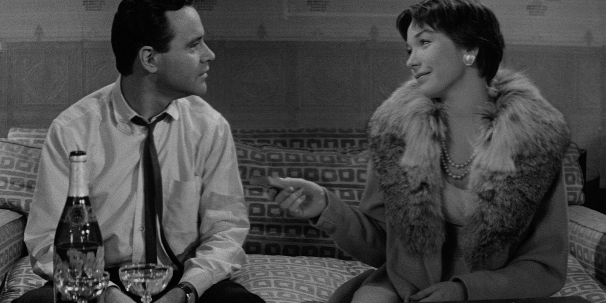 Jack Lemmon and Shirley MacLaine in The Apartment, sitting together in a couch playing cards