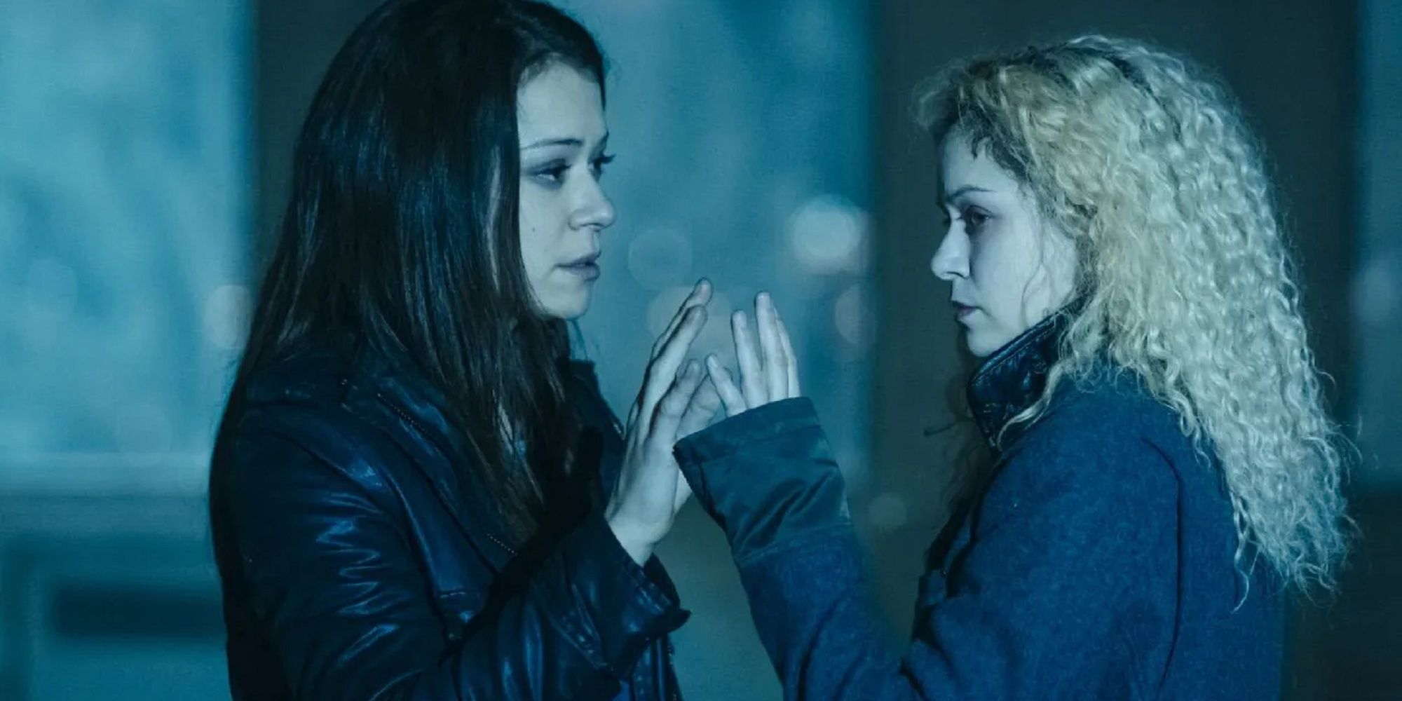 Sarah Manning touching hands with her blonde-haired clone in 'Orphan Black.'