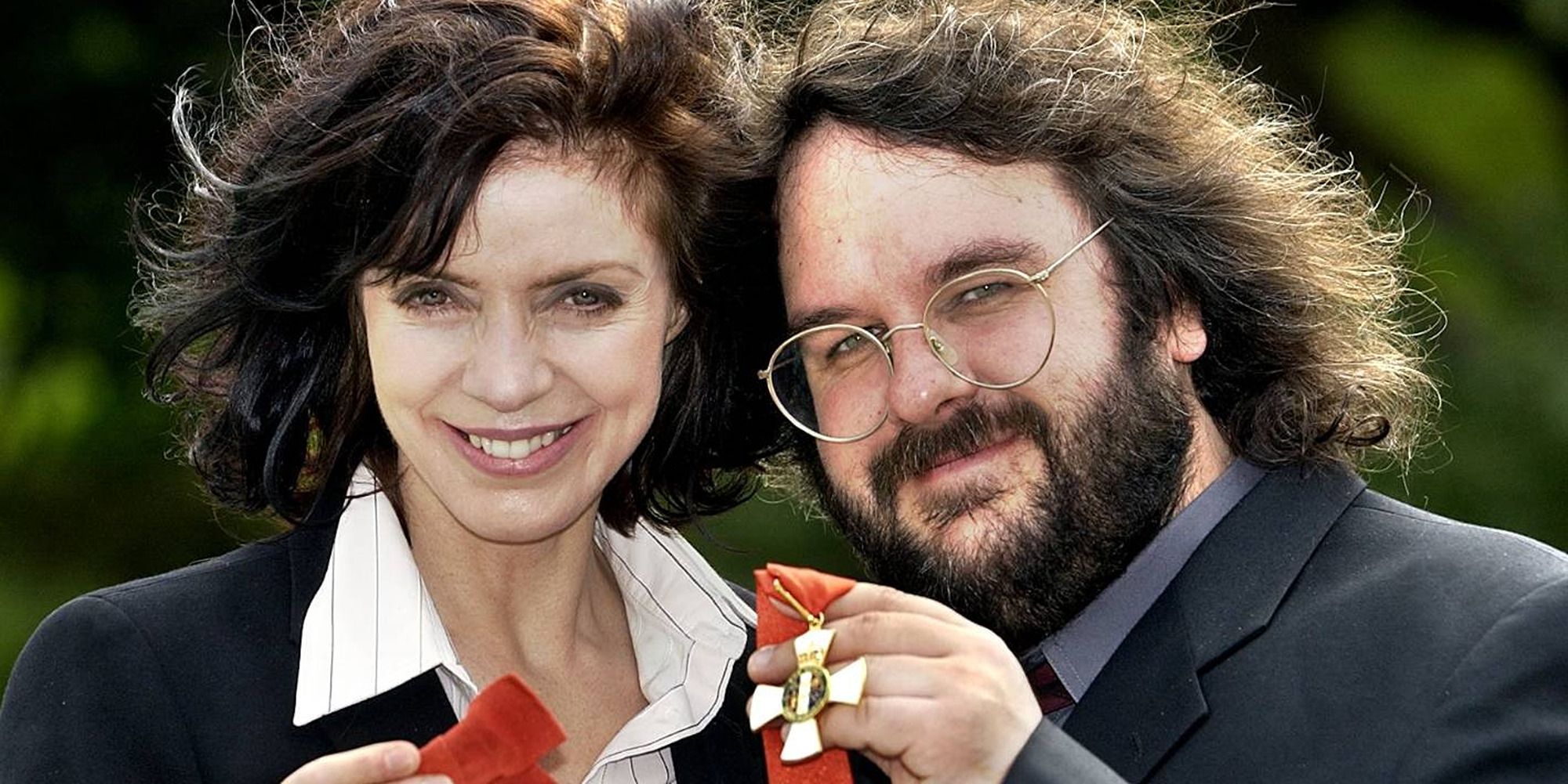 Peter Jackson and Fran Walsh at her Damehood declaration, holding the medal