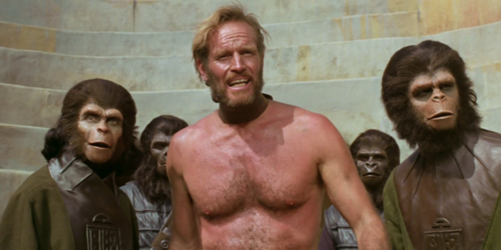 Charlton Heston as George Taylor surrounded by apes in Planet of the Apes