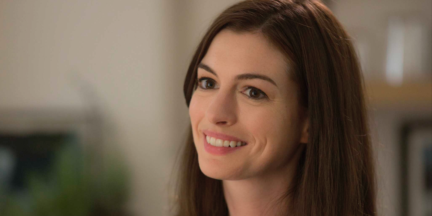 Anne Hathaway smiling at someone off-camera.