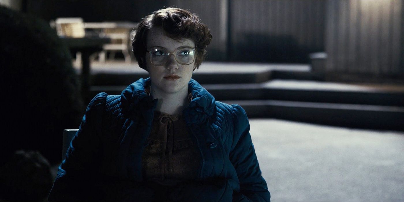 Shannon Purser as Barb Holland staring somberly in the Stranger Things series.