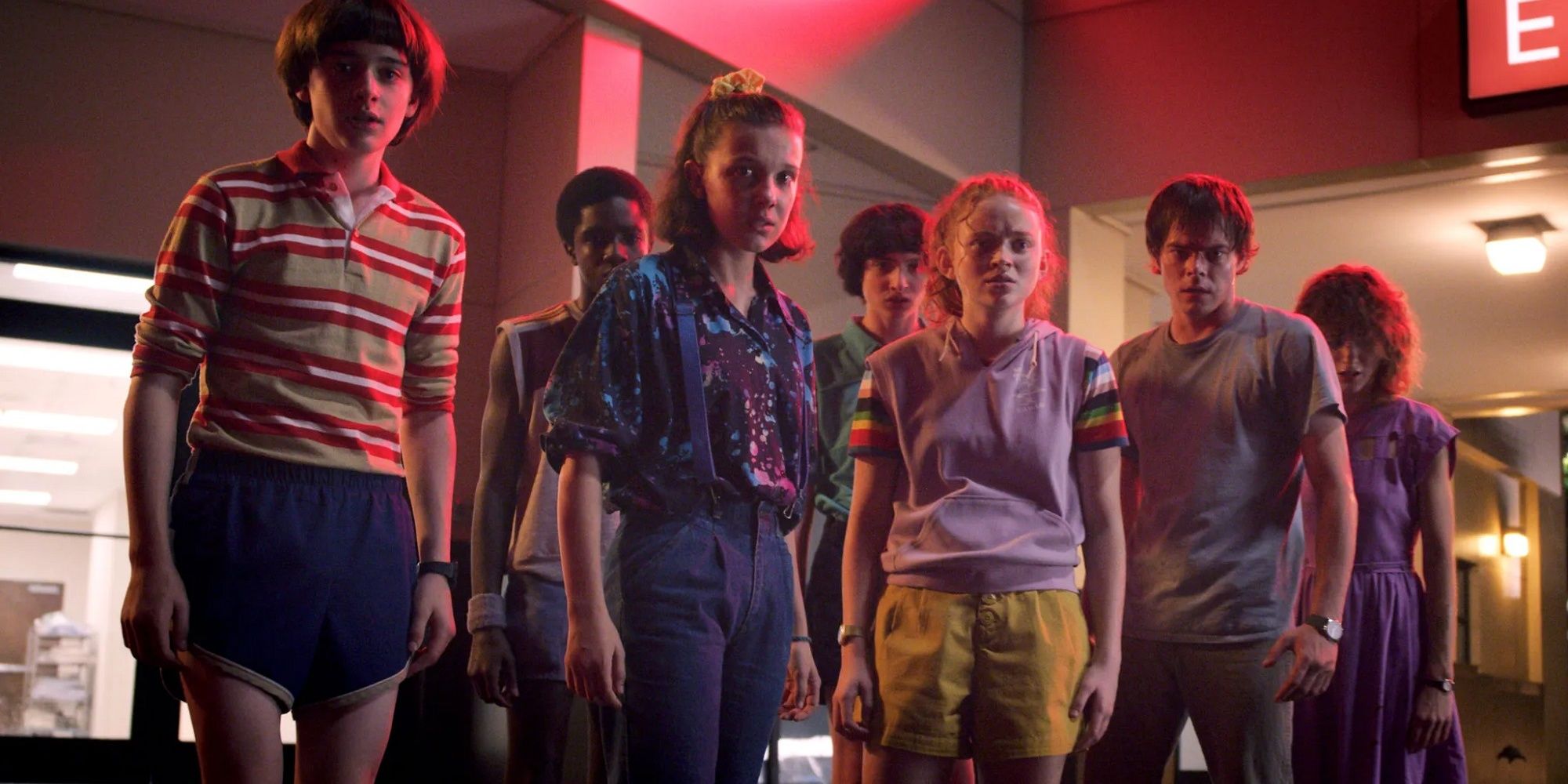Eleven and friends in standing around together in &lsquo;Stranger Things.'