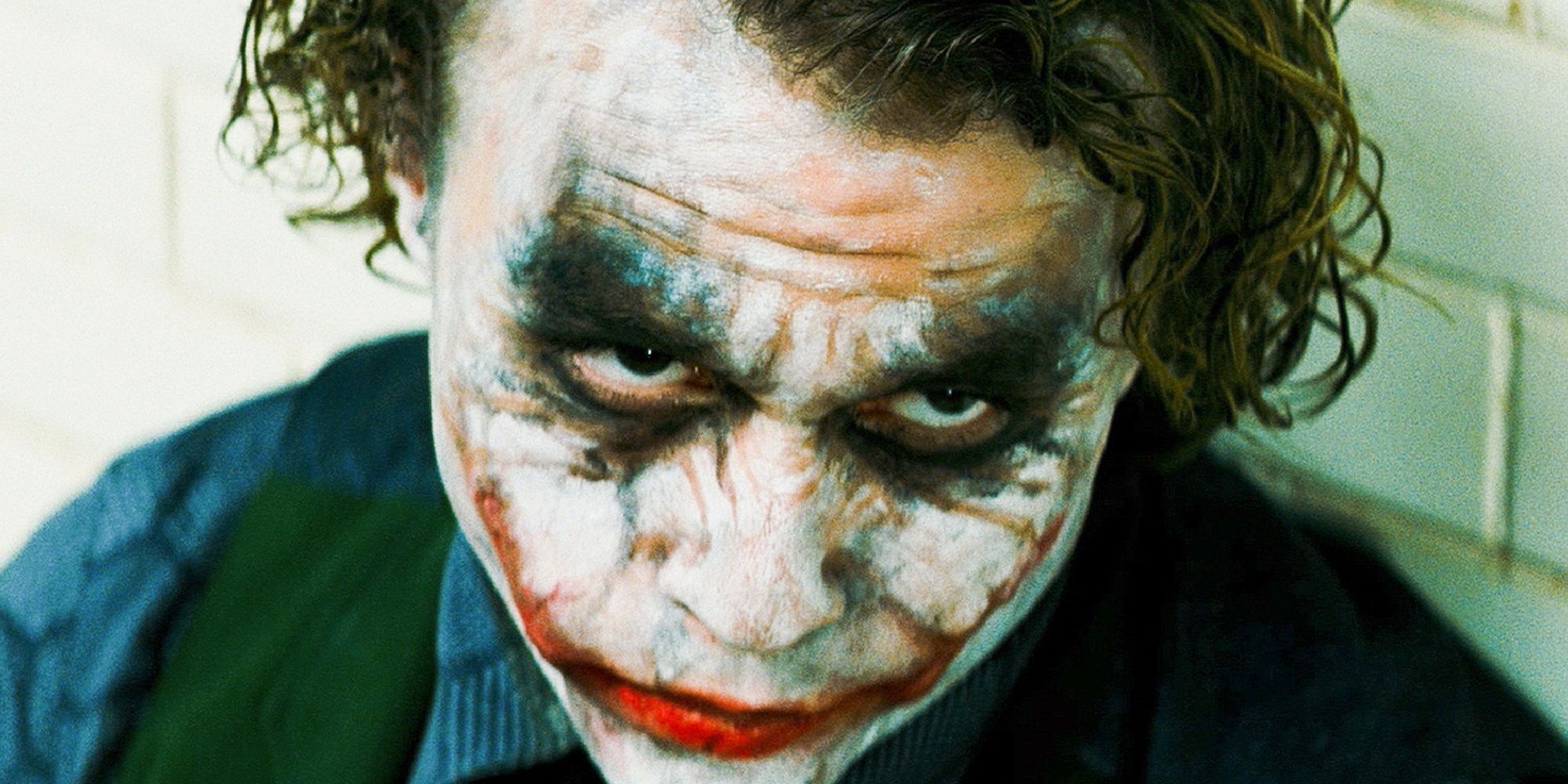 The Joker sitting on the floor of the interrogation room in The Dark Knight.