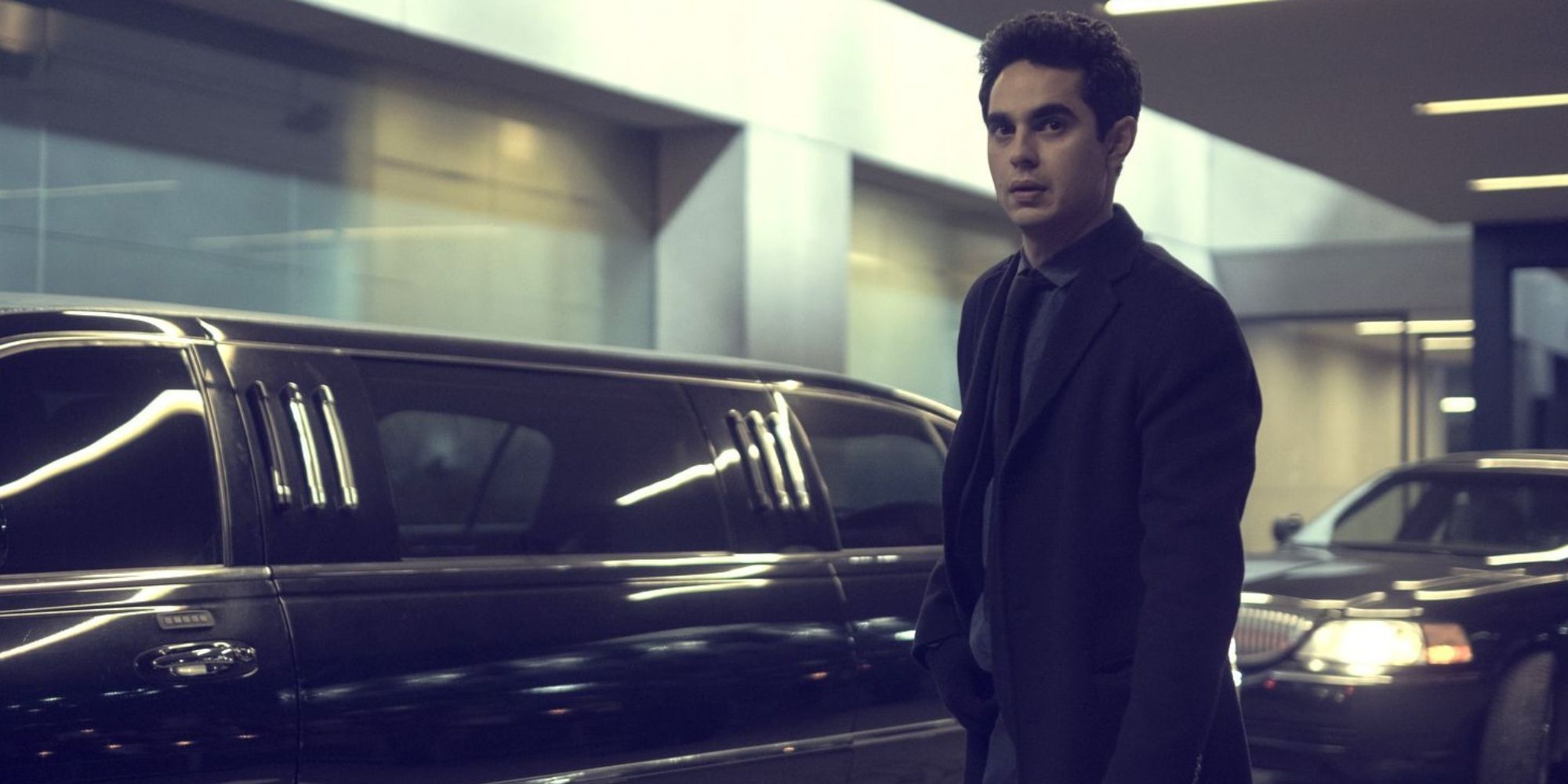 Nick Blaine standing next to a black car