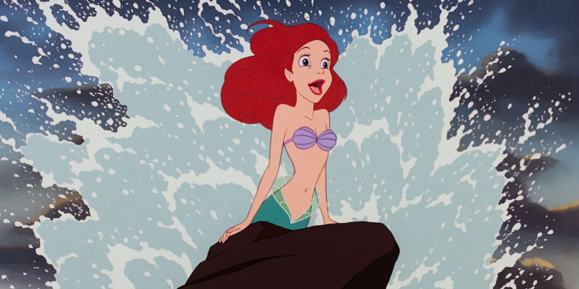 Ariel sitting on a rock with a wave crashing behind her