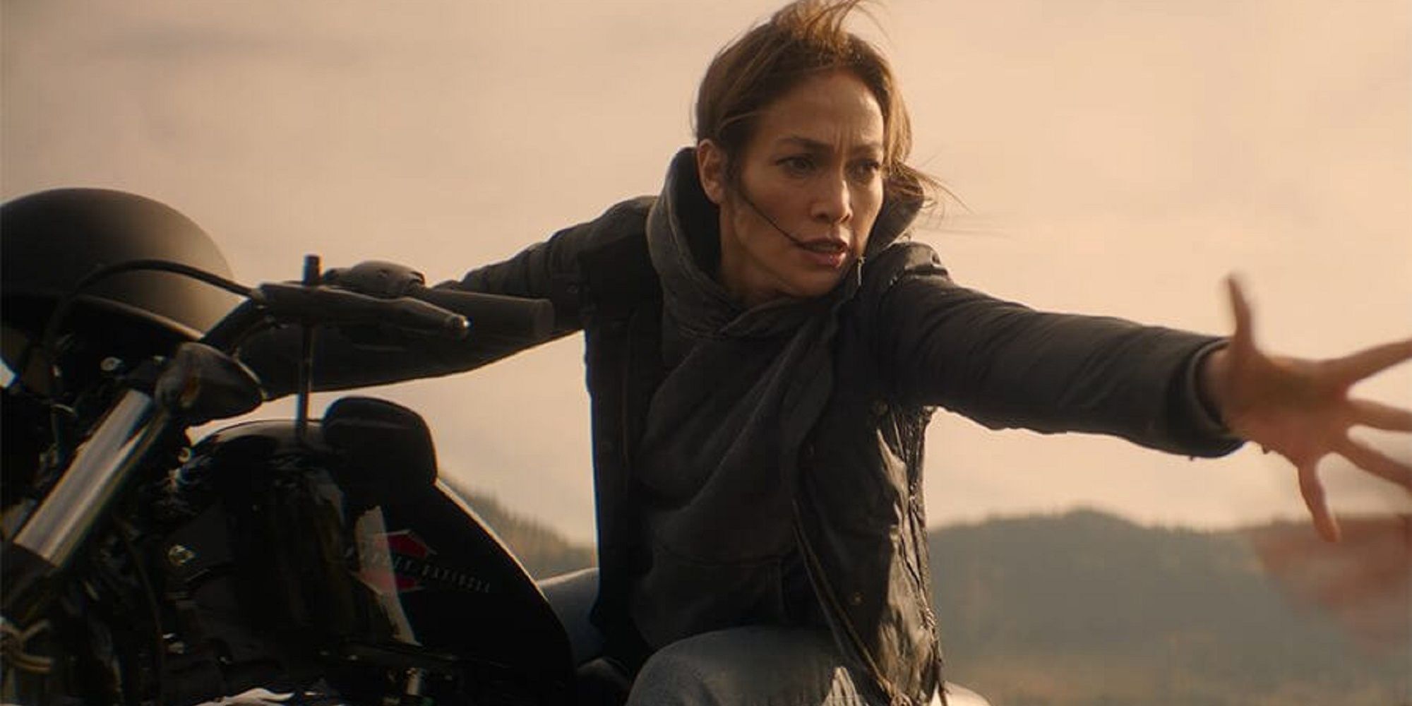 Jennifer Lopez' character reaching out her hand while on a motorcycle in 'The Mother.'
