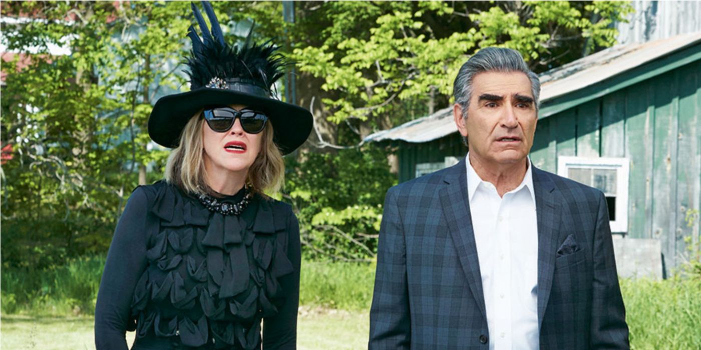 Moira and Johnny Rose from Schitt's Creek all dressed up, looking shocked and disappointed at something.