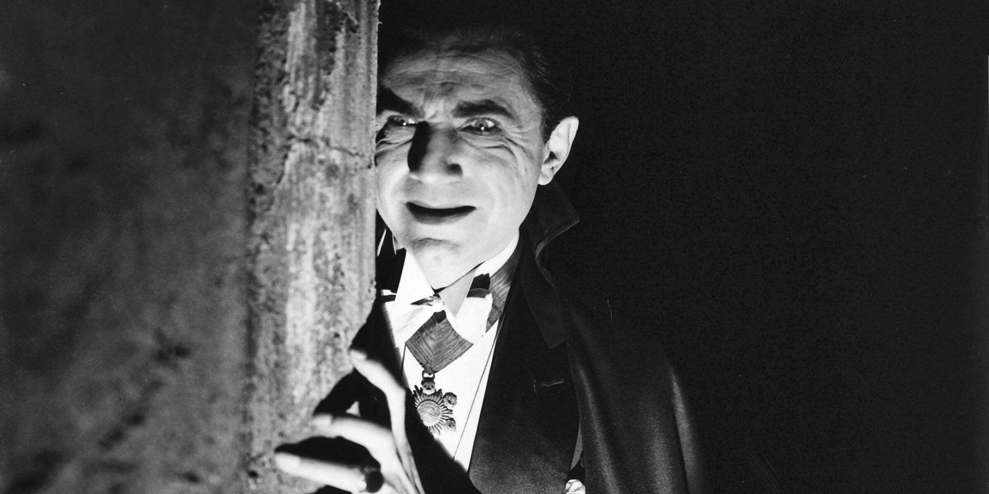 Count Dracula smiles menacingly from behind a shadowy corner