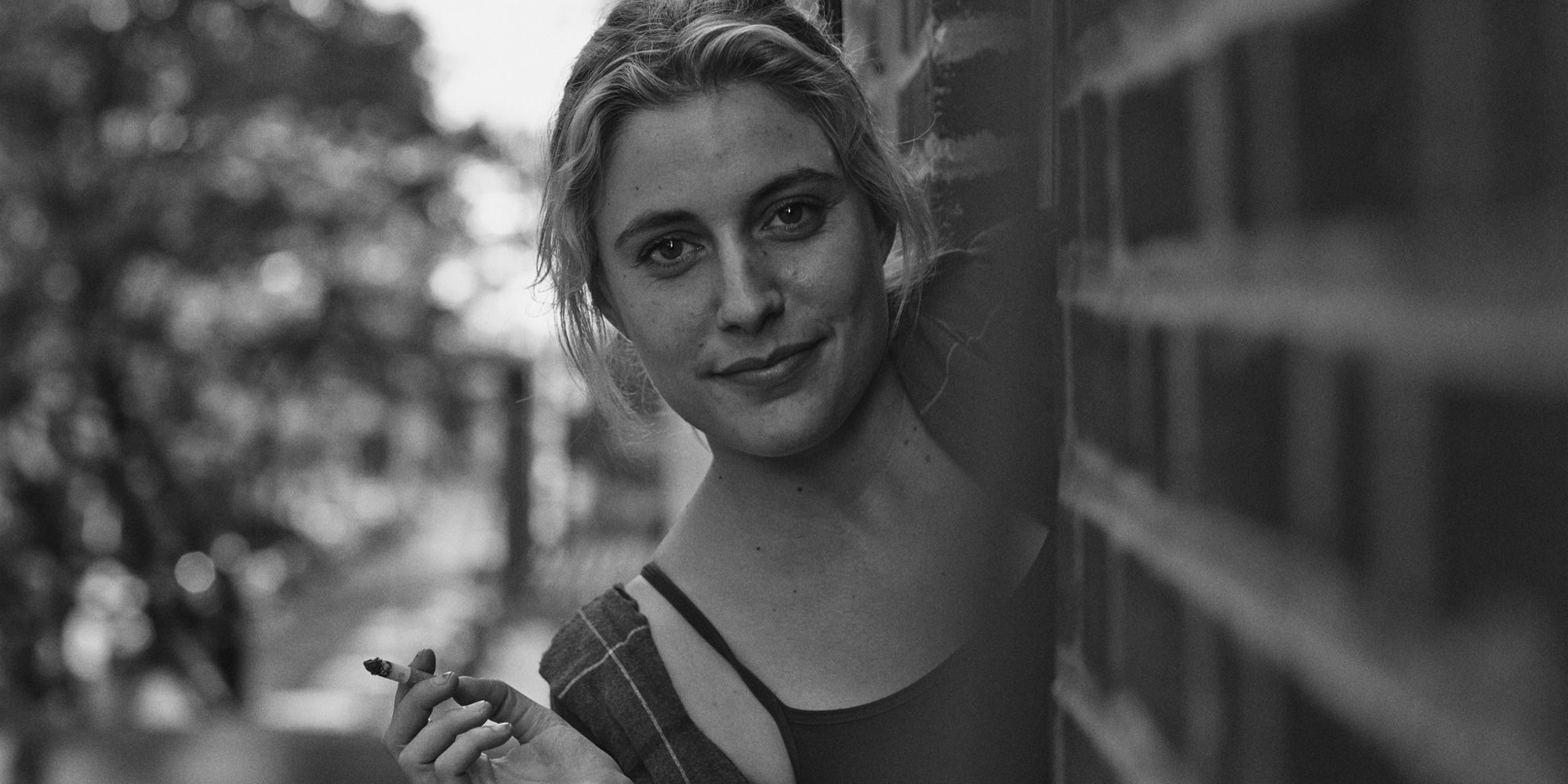 Greta Gerwig as Frances peeking through a wall in Frances Ha.