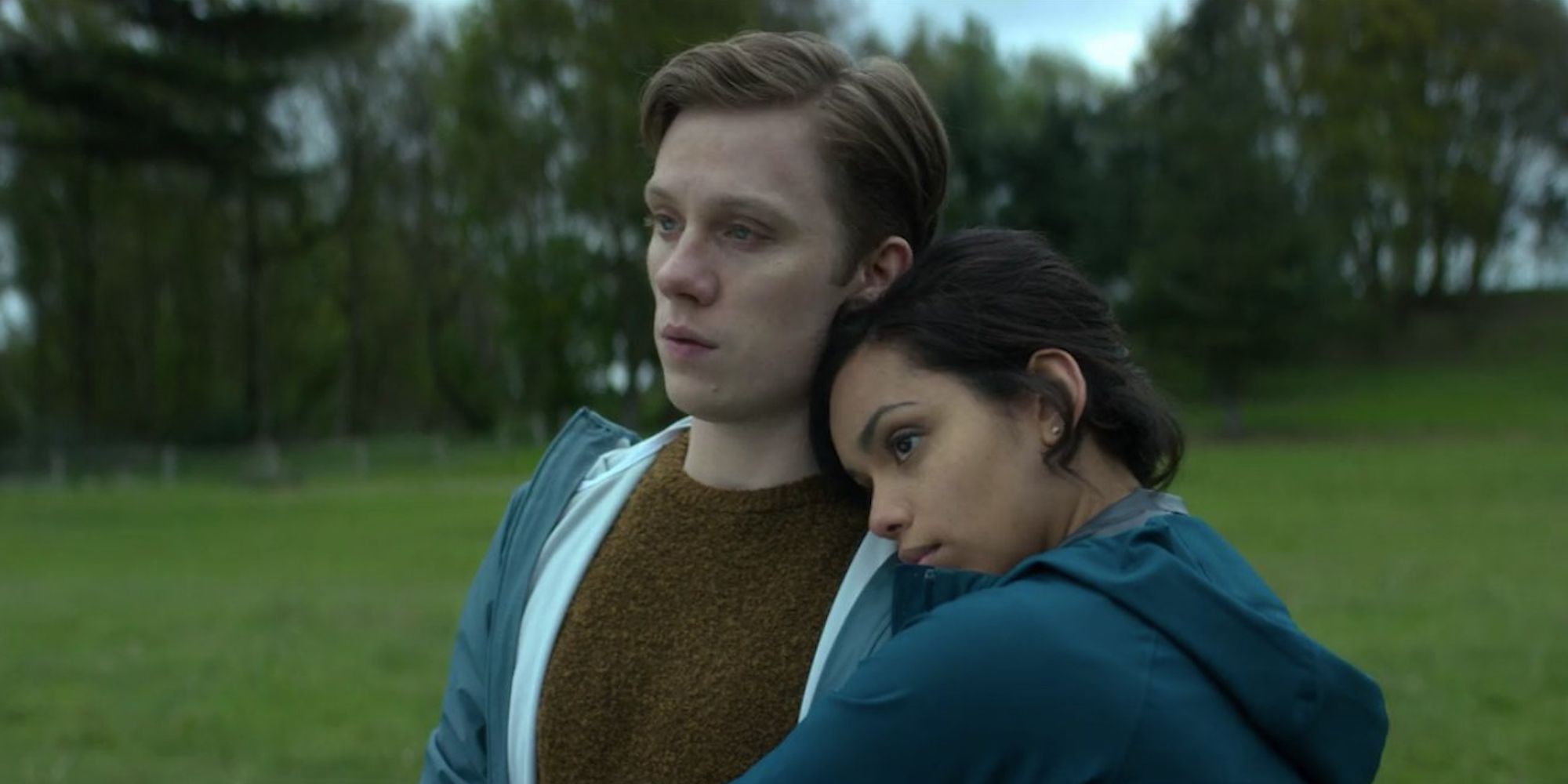 Georgina Campbell as Amy leaning on Joe Cole as Frank as the two look at the horizon in Hang the DJ Black Mirror.