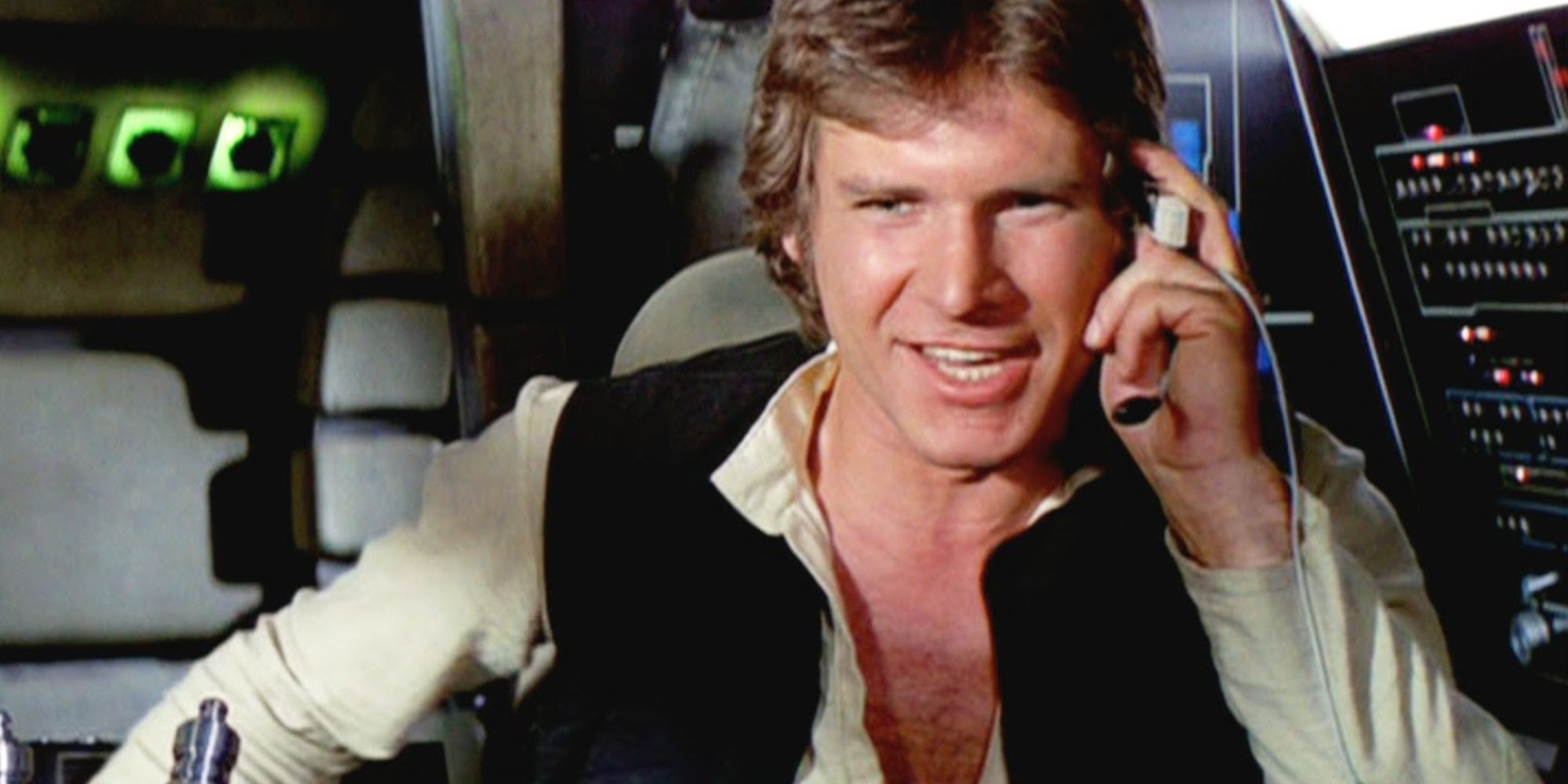 Han Solo sits in the cockpit of the Millennium Falcon, talking to Luke Skywalker on the radio