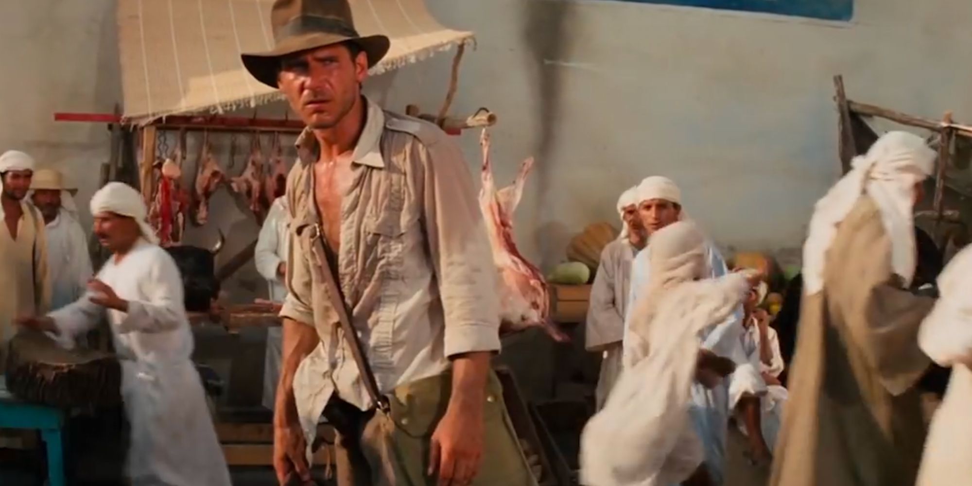 Indiana Jones, surrounded by Egyptian citizens, prepares for a fight