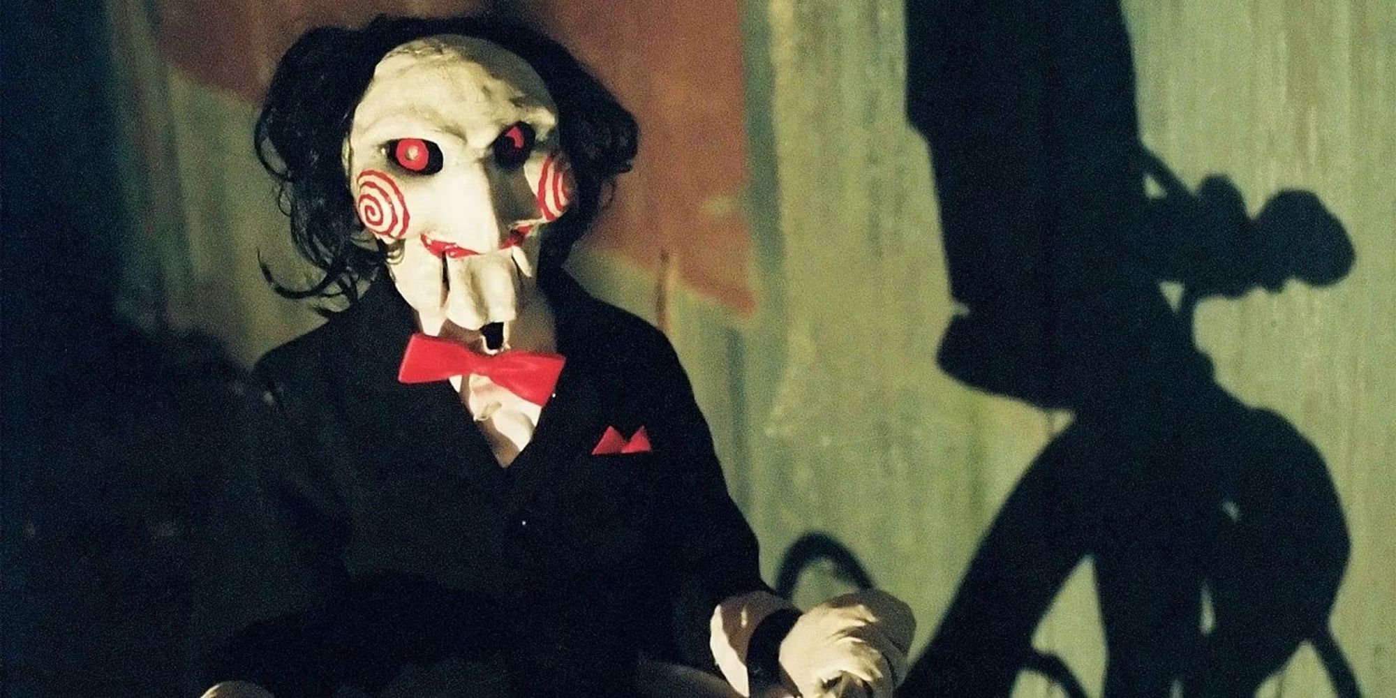 A Jigsaw puppet on a tricycle from Saw