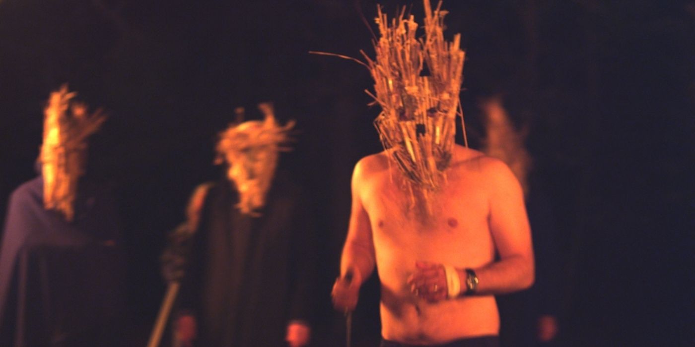 Still from 'Kill List': cult members wearing straw masks.