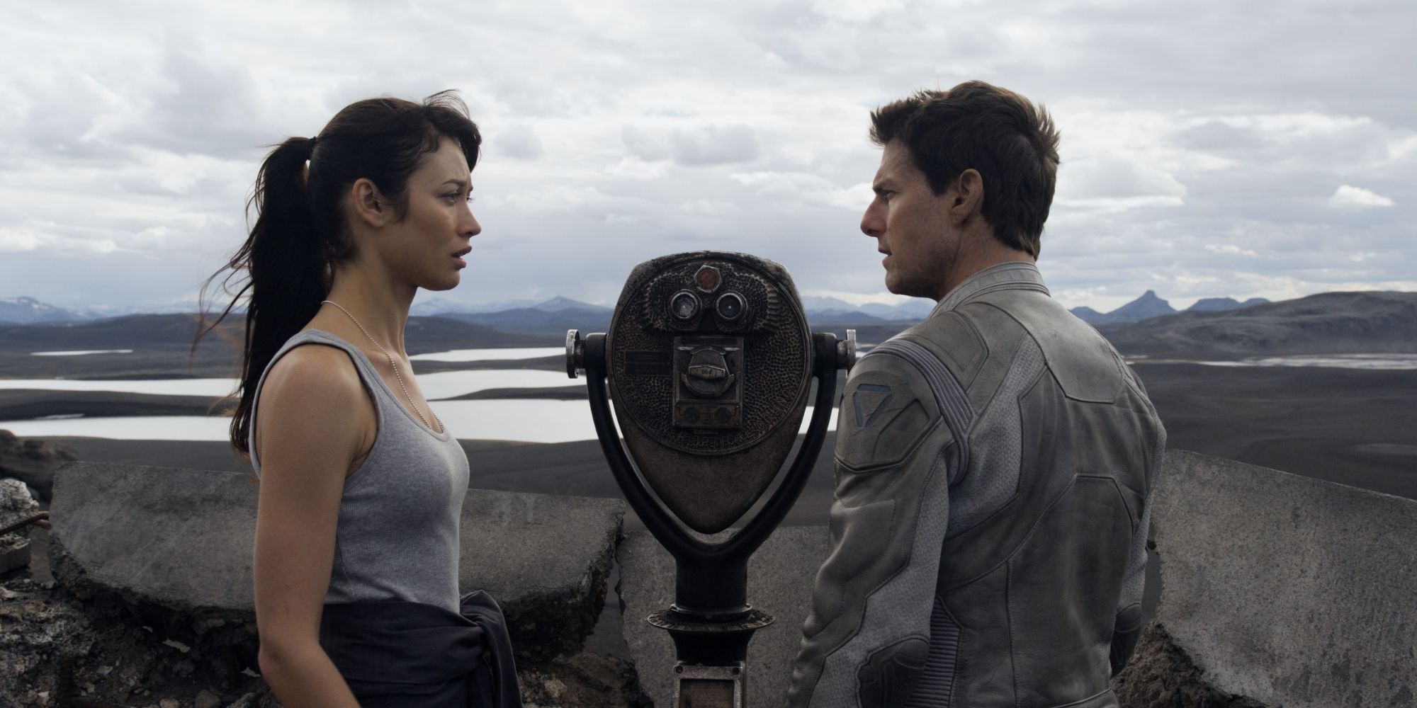 Jack and Julia stare out at the coast using an old pair of binoculars