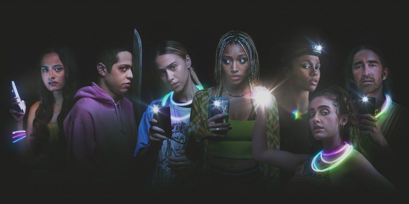 A banner featuring the main characters of “Bodies Bodies Bodies” in the dark, holding phones with the lights on.