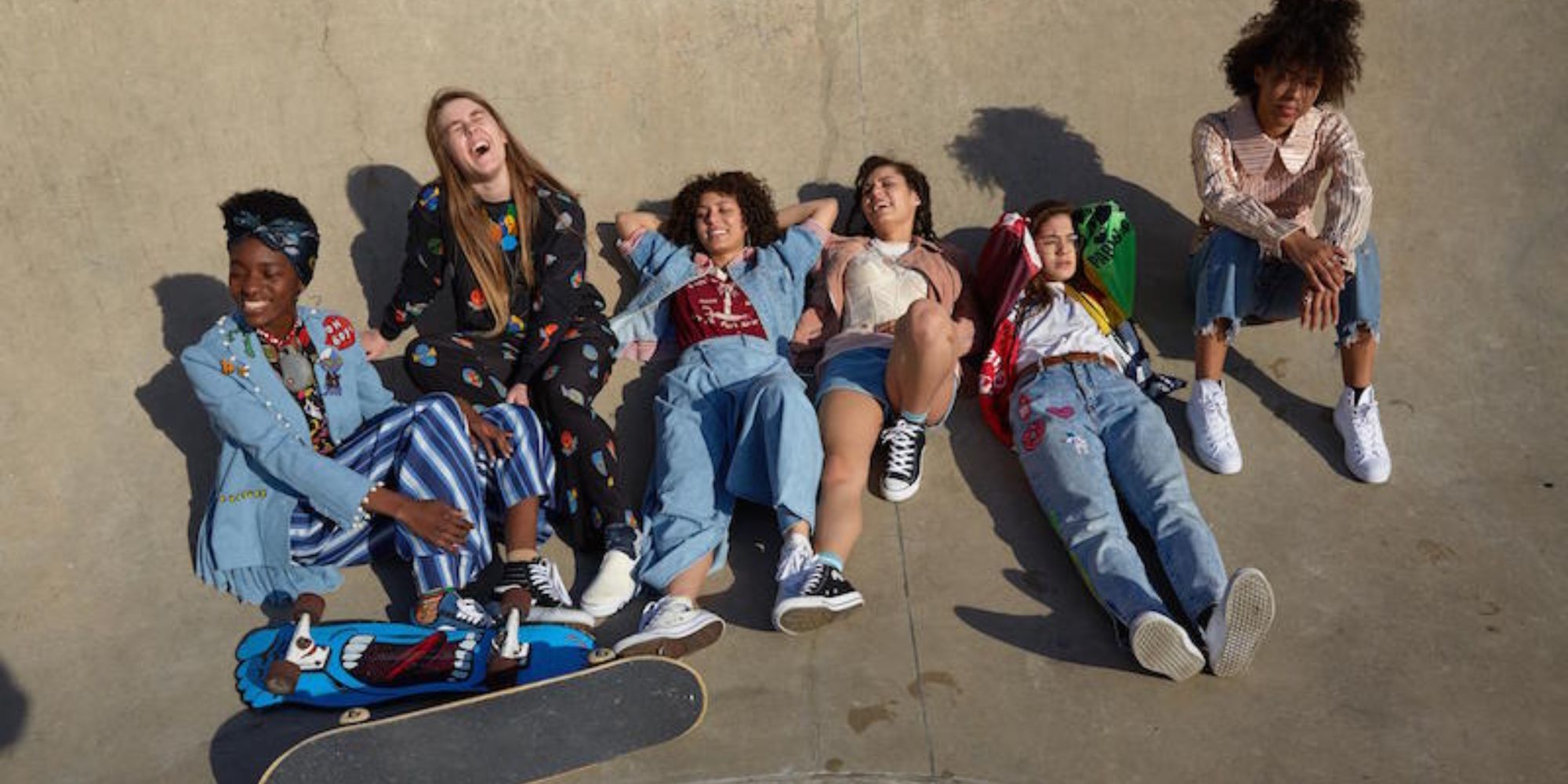 a group of female skaters lying in the pit
