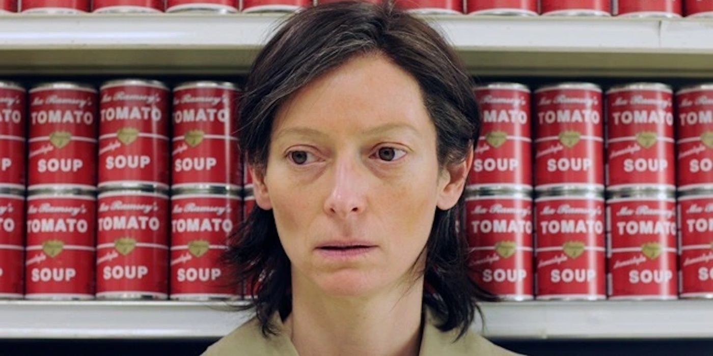 Eva leaning against a supermarket aisle while looking pensive in We Need to Talk About Kevin