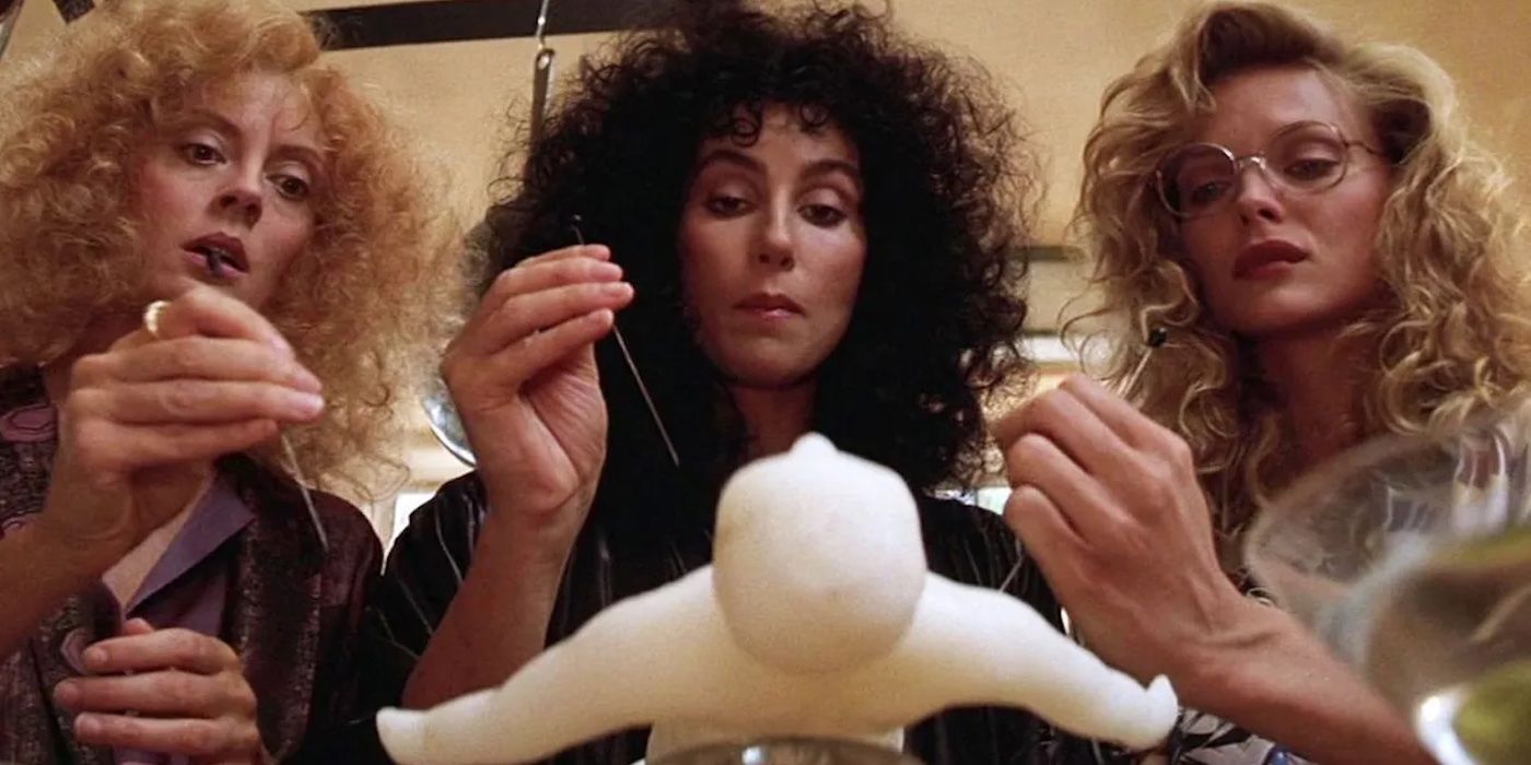 Susan Sarandon, Cher, and Michelle Pfeiffer stick pins in a doll in The Witches of Eastwick.