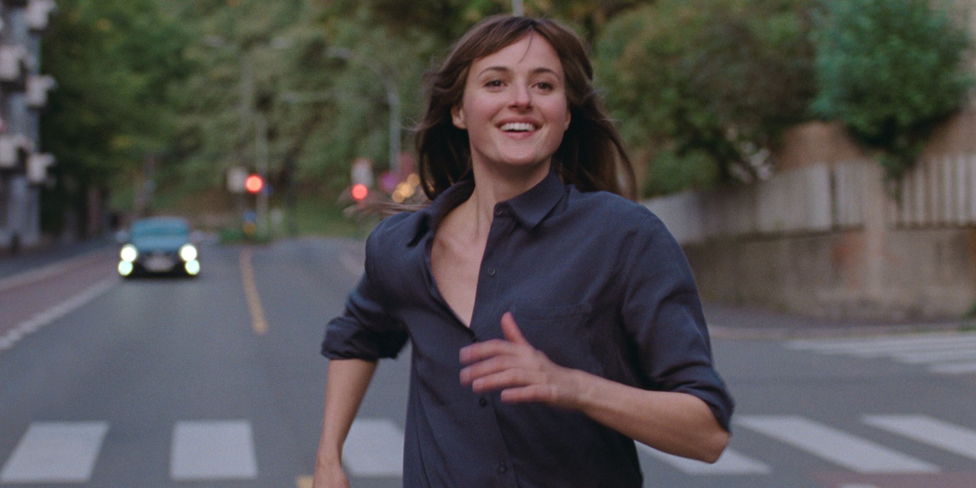 Renate Reinsve as Julie running down the street in The Worst Person in the World