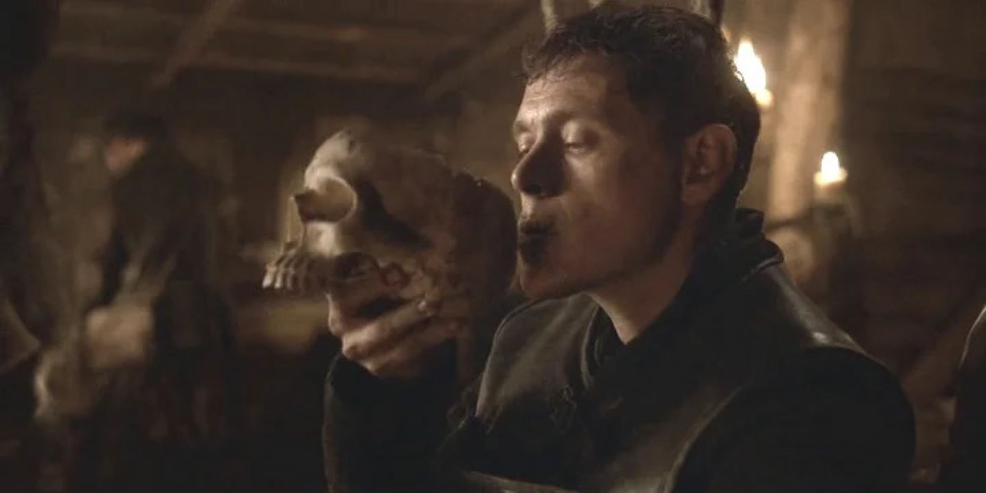 Close up on a man drinking from a skull
