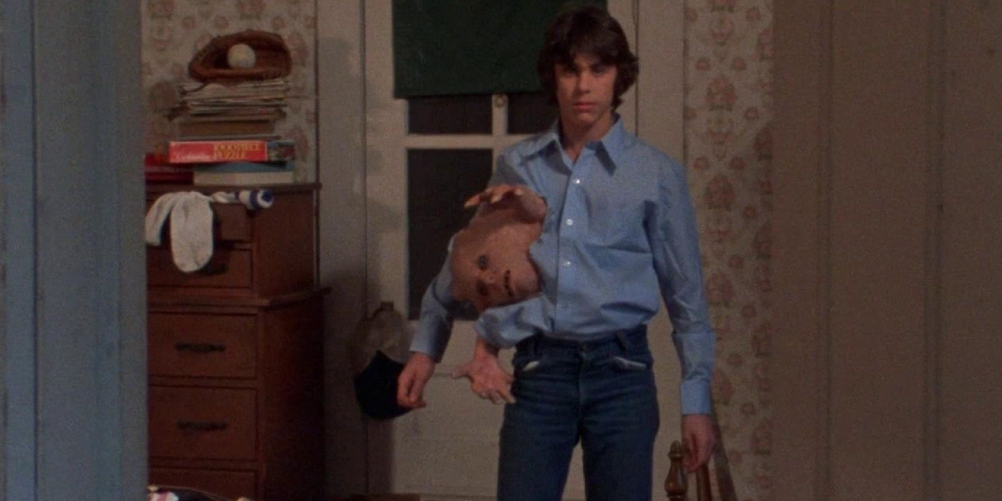 Duane holding Belial in his shirt in 'Basket Case.'