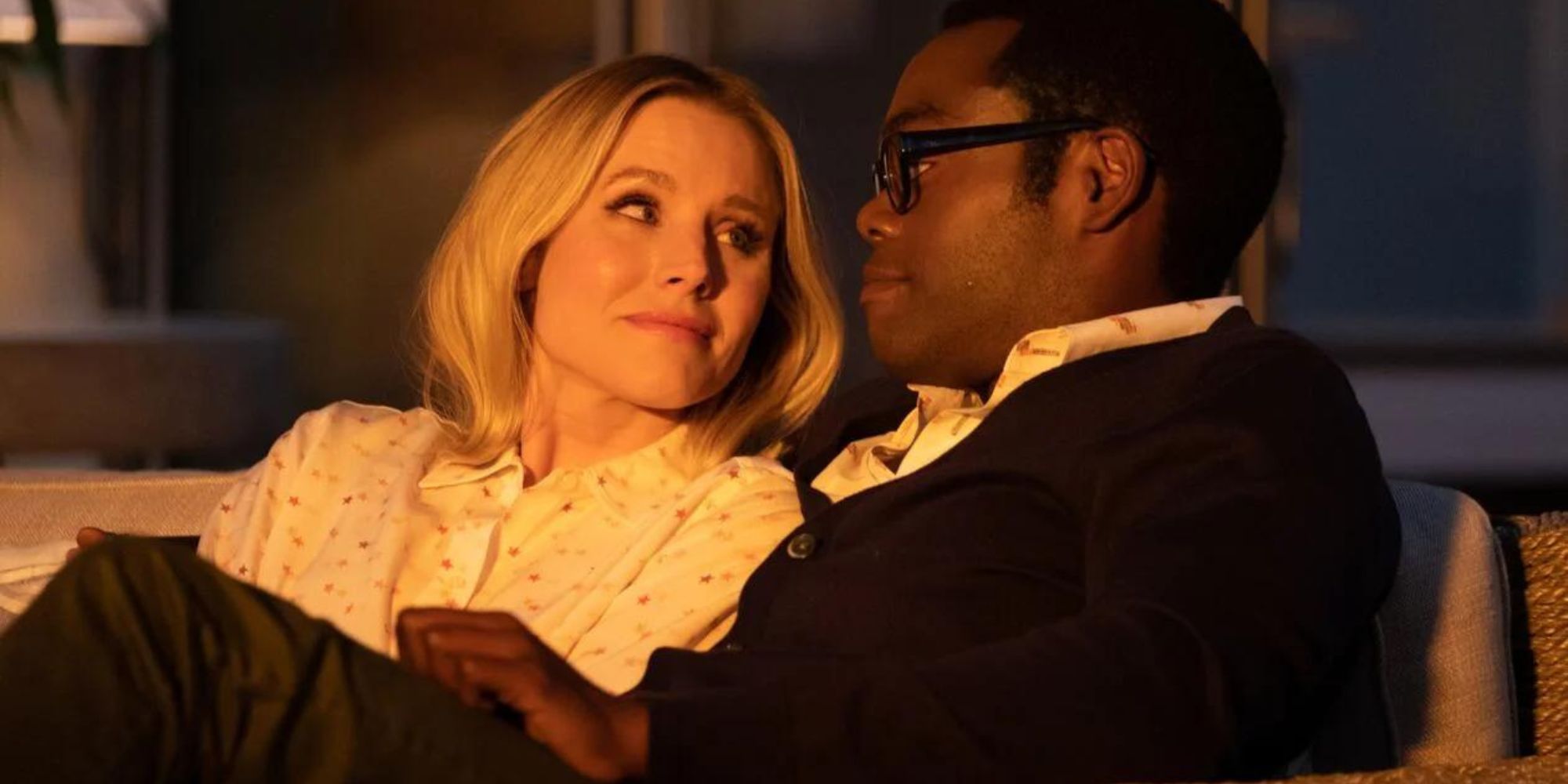 Chidi and Eleanor from The Good Place sitting on a couch together