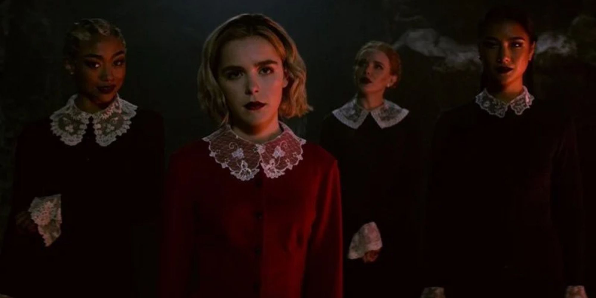 Sabrina Spellman at the centre staring forward with three other witches behind her