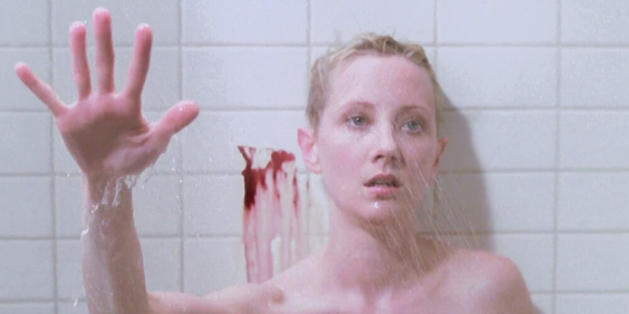 Anne Heche in the shower with her hand up 